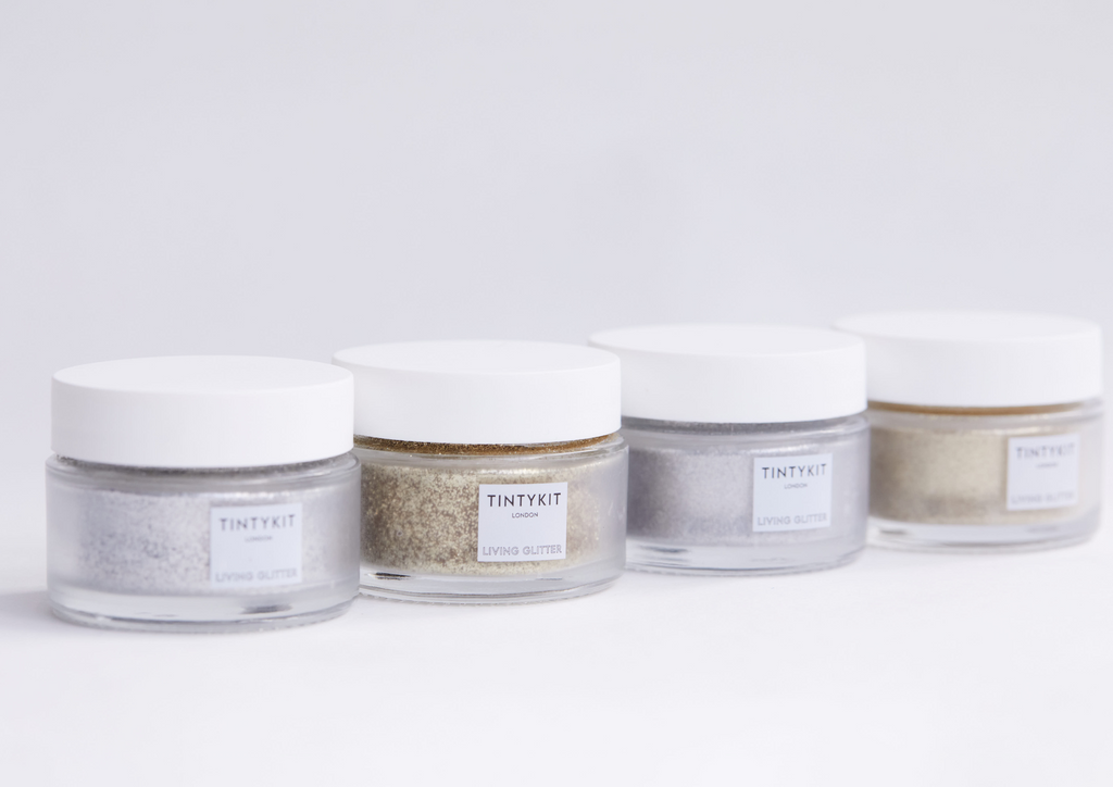 Product image of TINTYKIT LIVING GLITTER biodegradable glitter. Four jars – diagonal view.